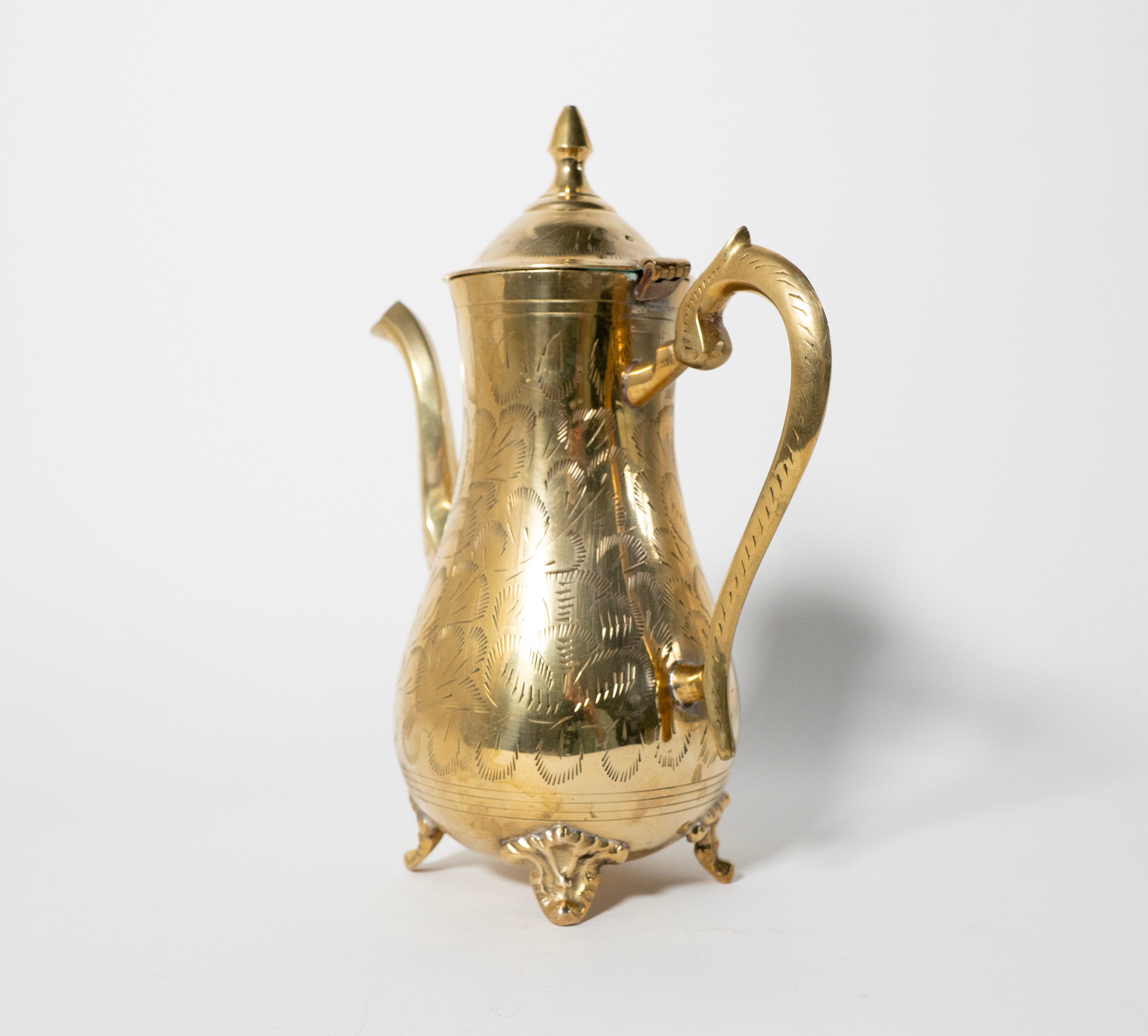 Gold coffee pot on a white background