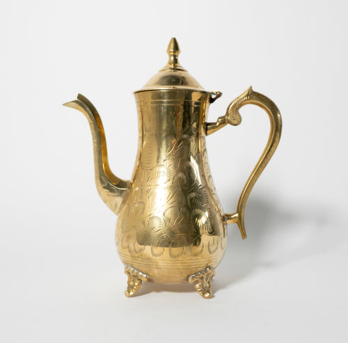Gold embossed teapot on a white background