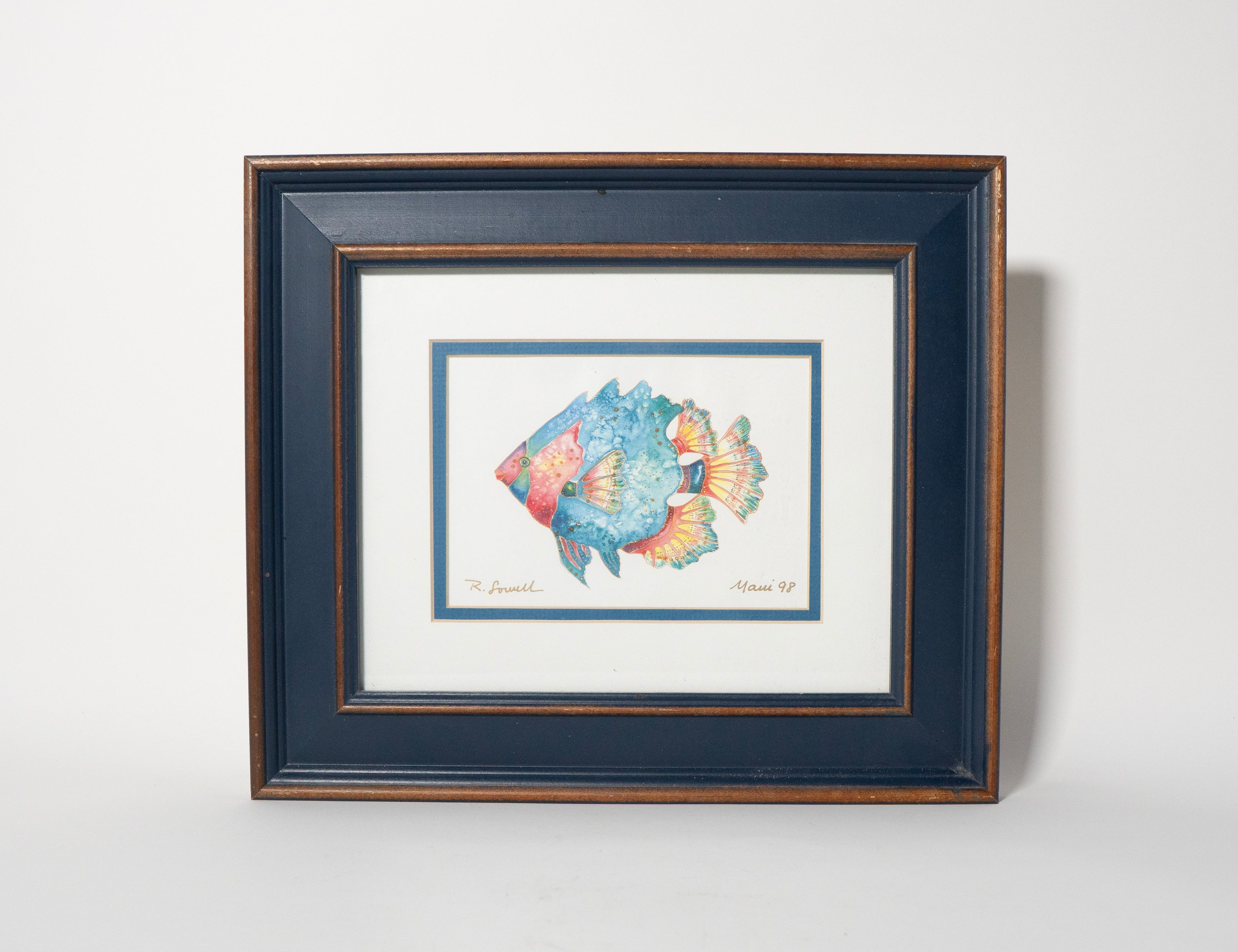 Framed artwork of a colorful fish on a white background