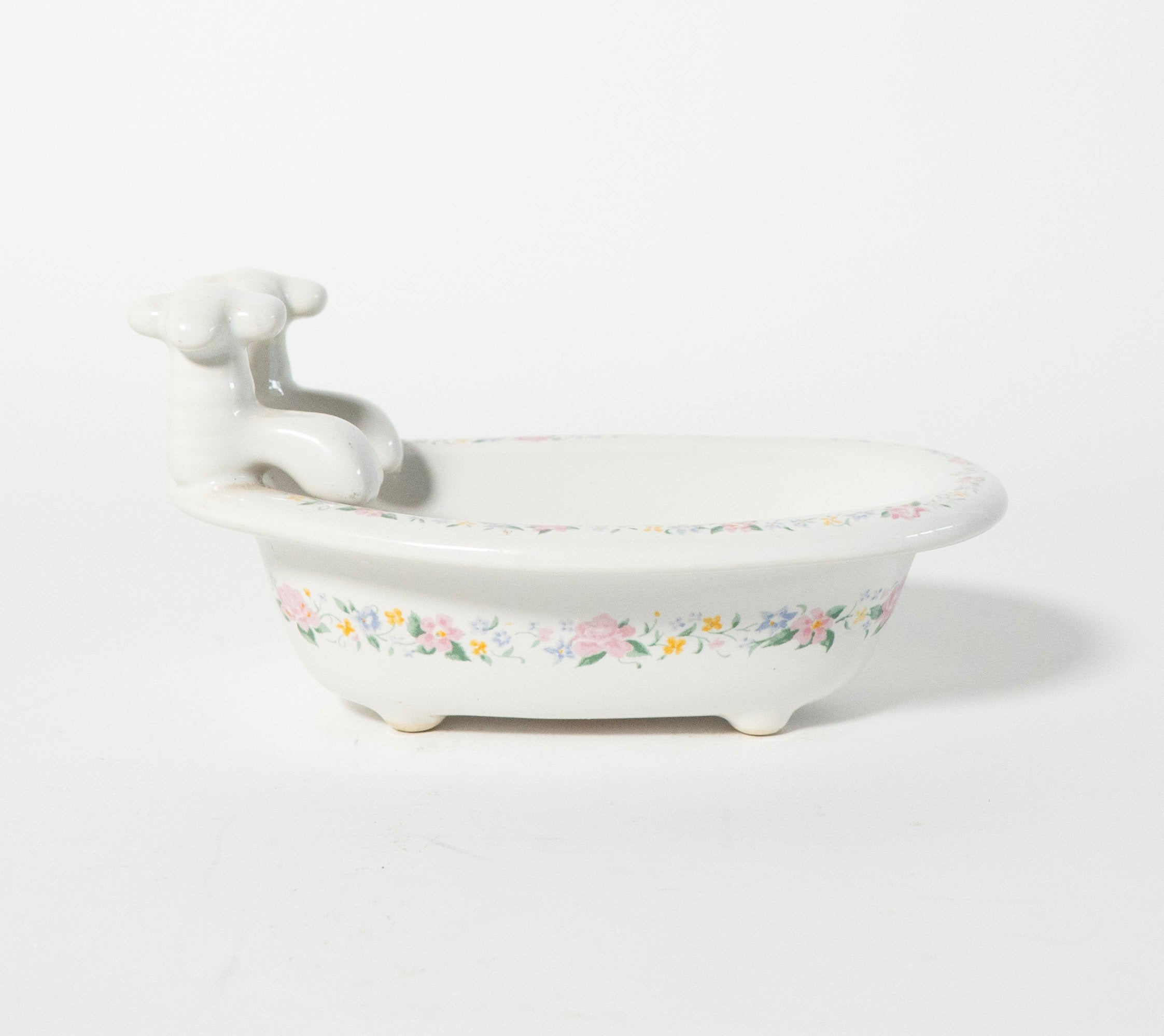 White ceramic sink with floral patterns on a white background