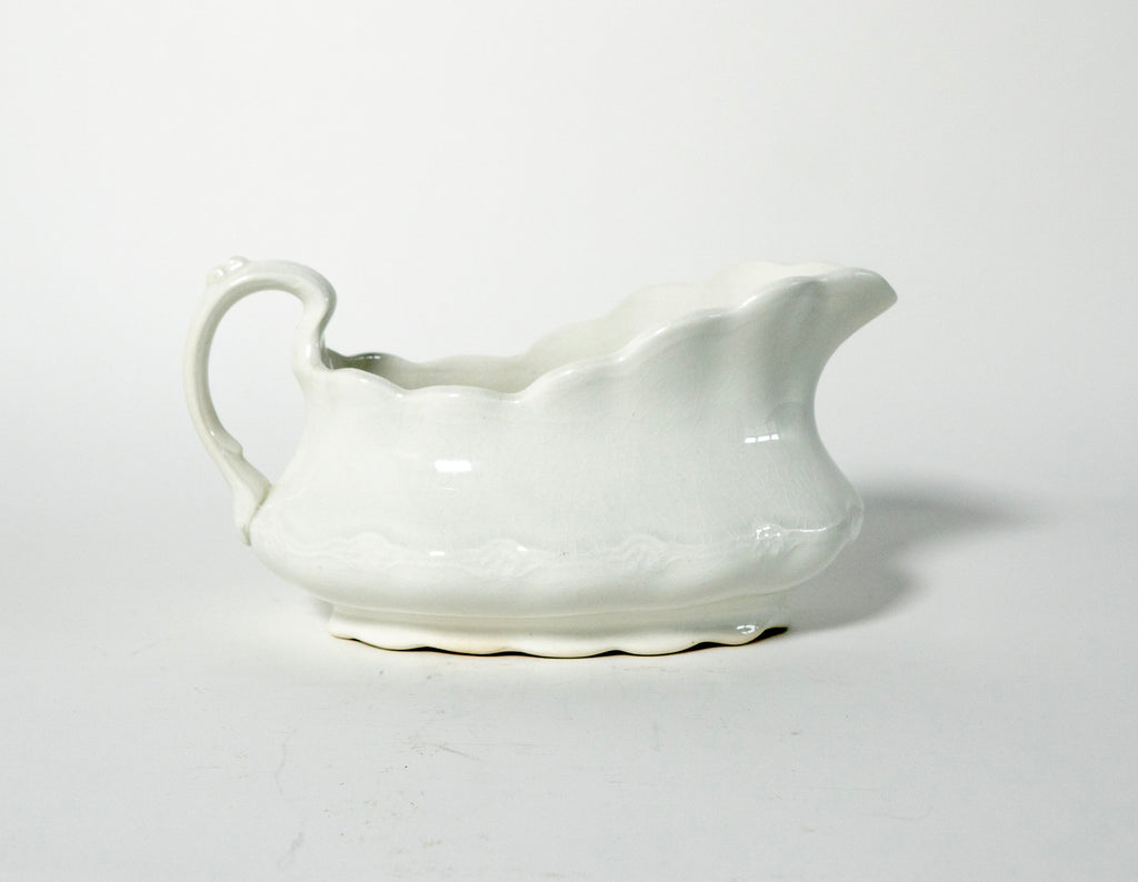 White ceramic gravy boat on a light gray background