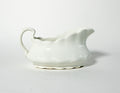 White ceramic gravy boat on a light gray background