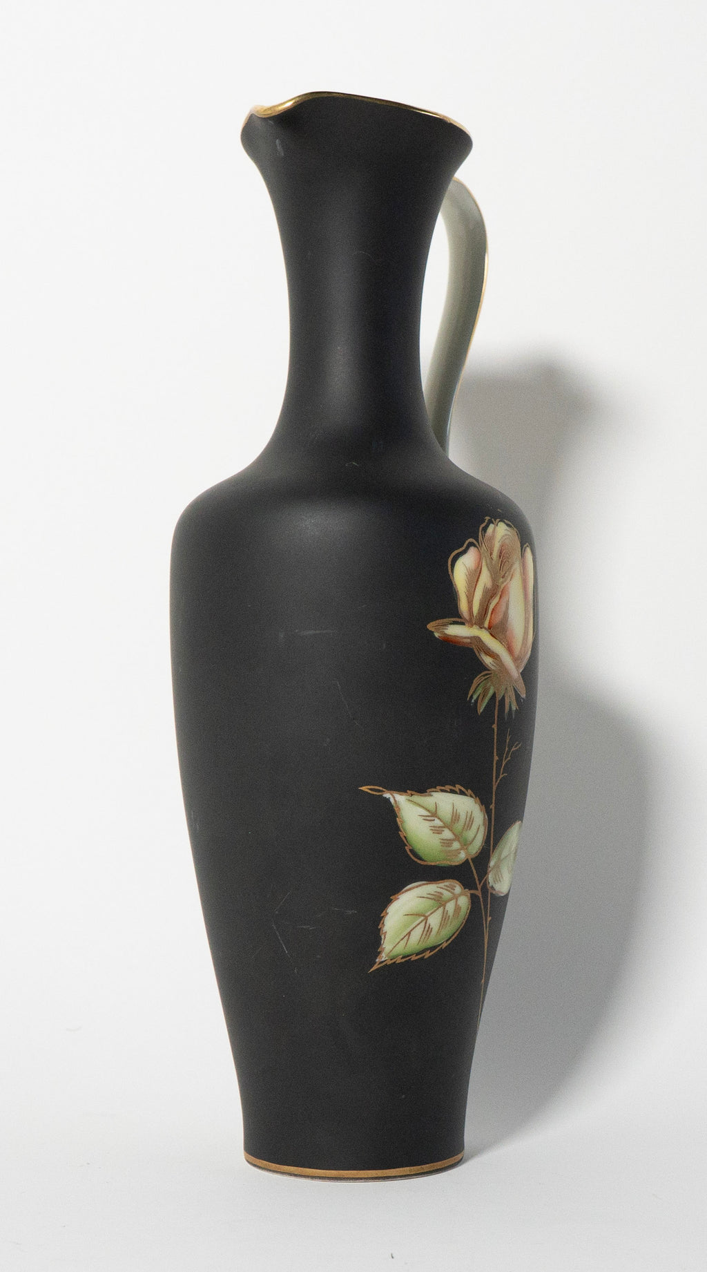 Black vase with floral design on a white background