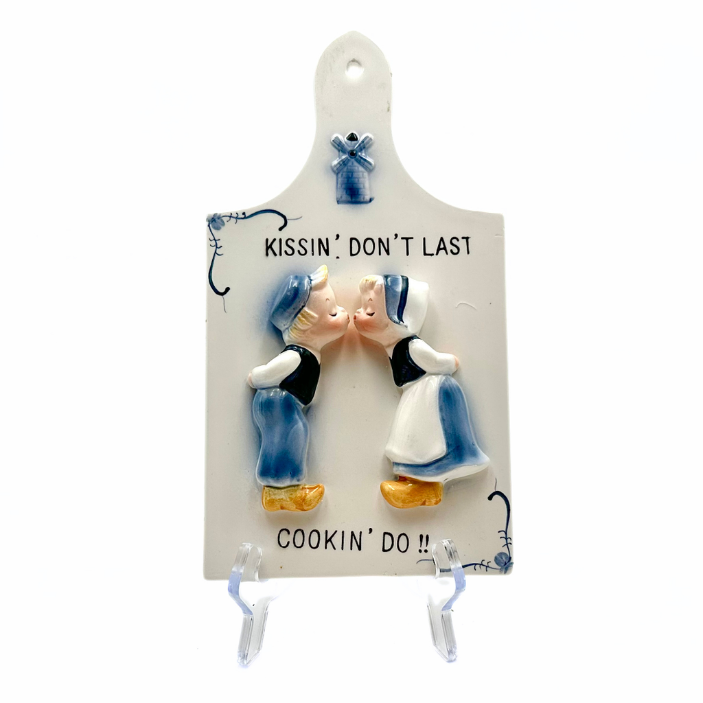 Kissin Don't Last Cookin Do Ceramic Dutch Wall Plaque