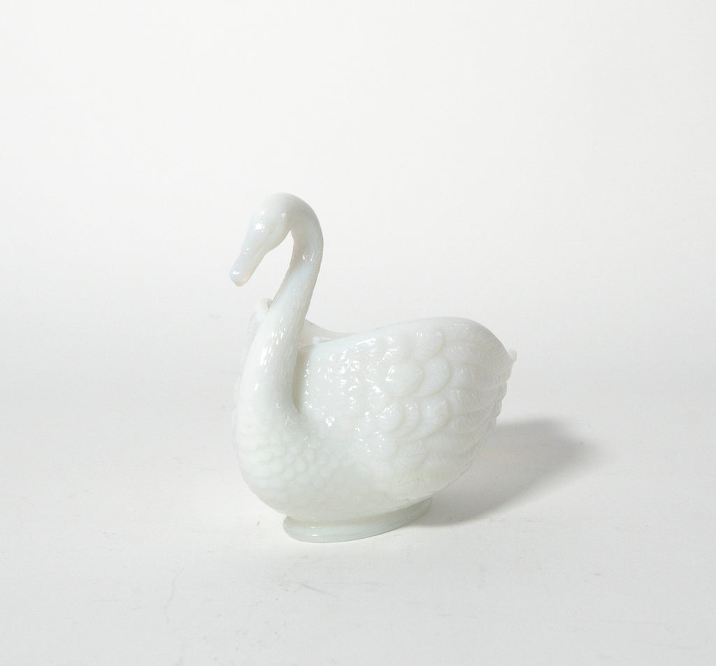 White ceramic swan on a light gray background