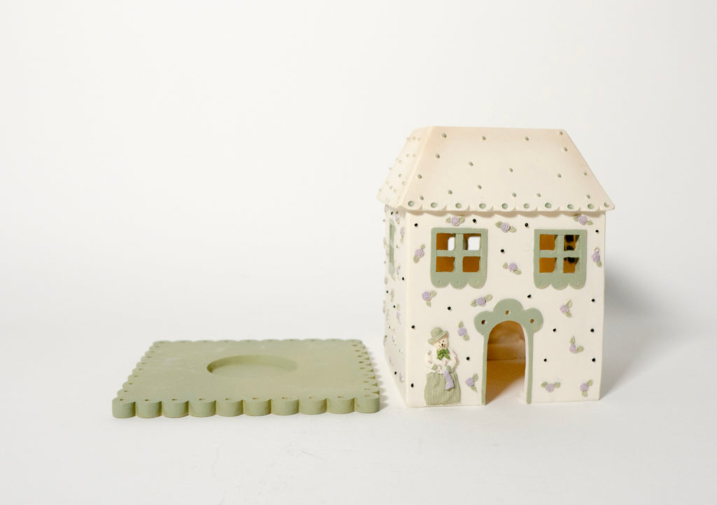 Tealight base and separate house topper on a white background