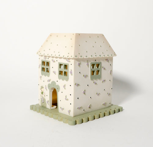 Decorative house-shaped light on a white background