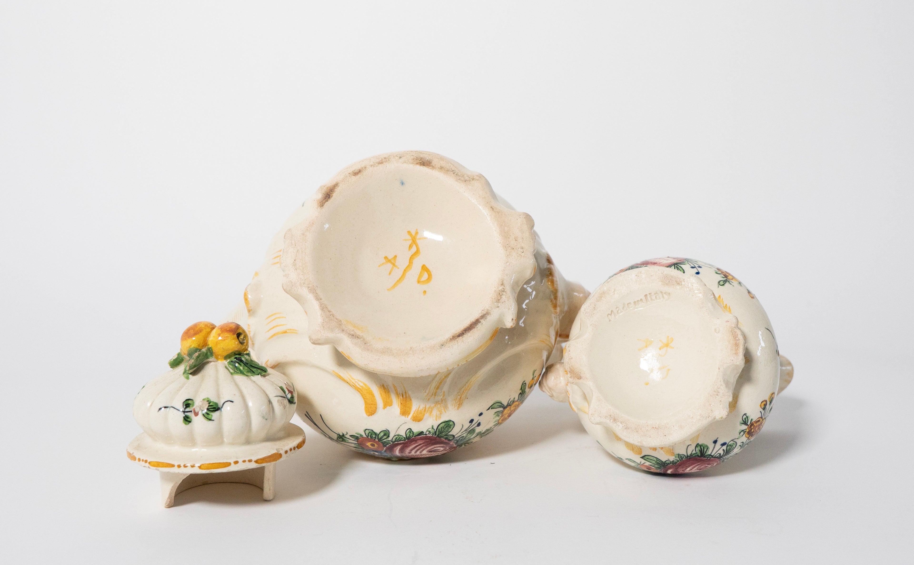 Three ceramic items with floral designs on a white background
