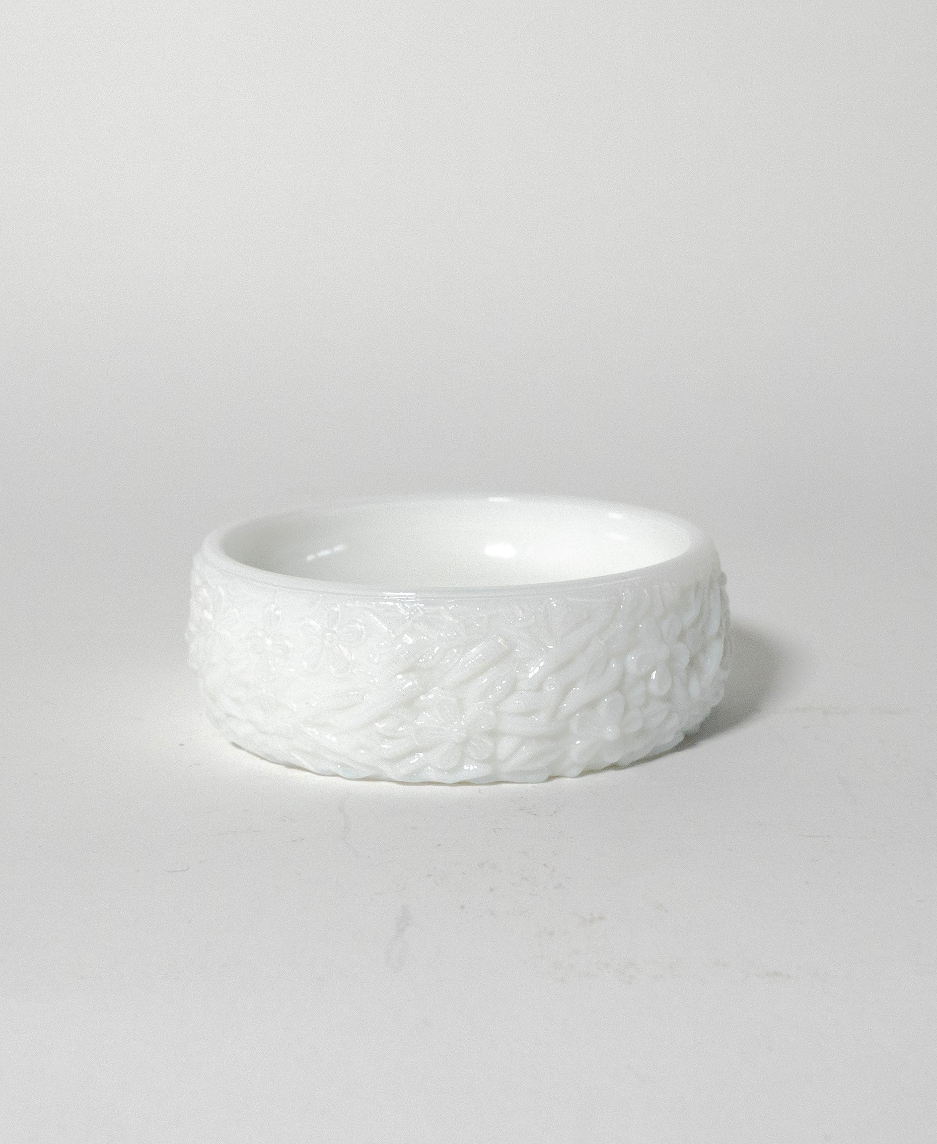 White textured ceramic bowl on a light gray background