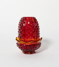 Red pressed glass fairy lamp on a white background