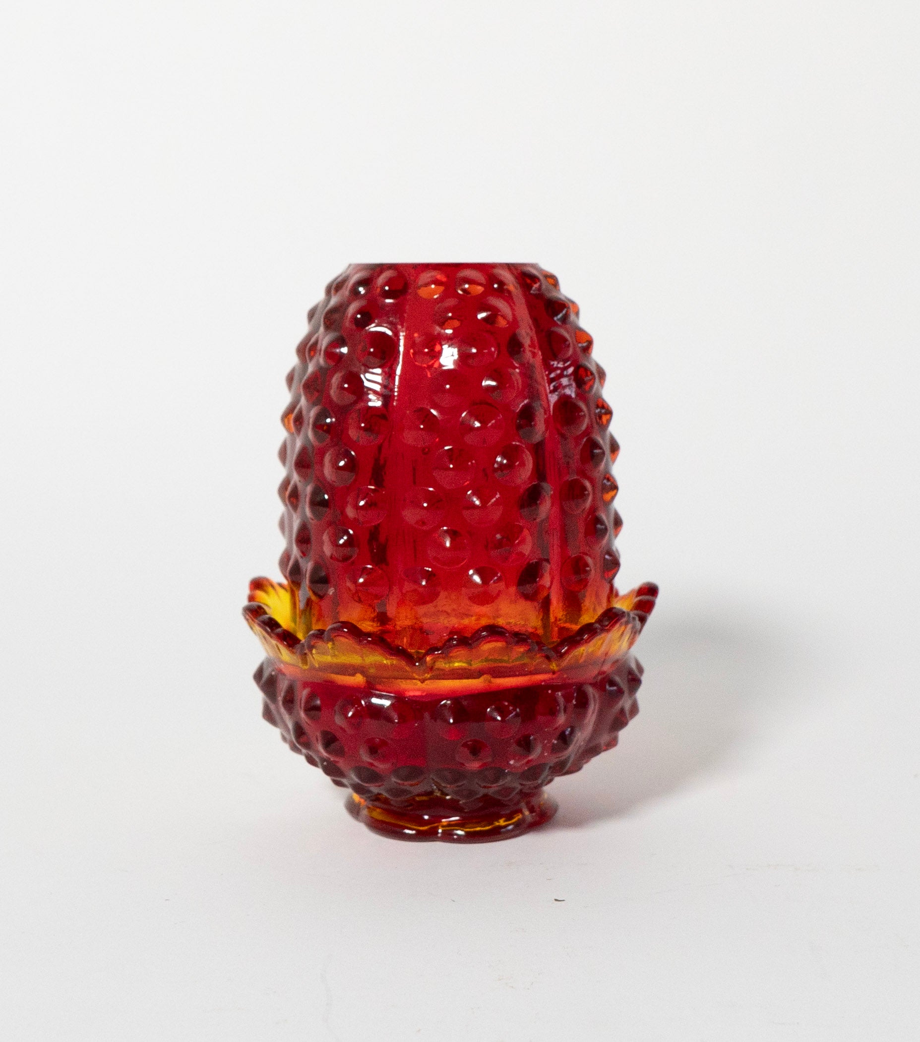 Red pressed glass fairy lamp on a white background