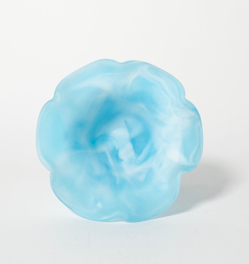 Blue flower-shaped object on a white background