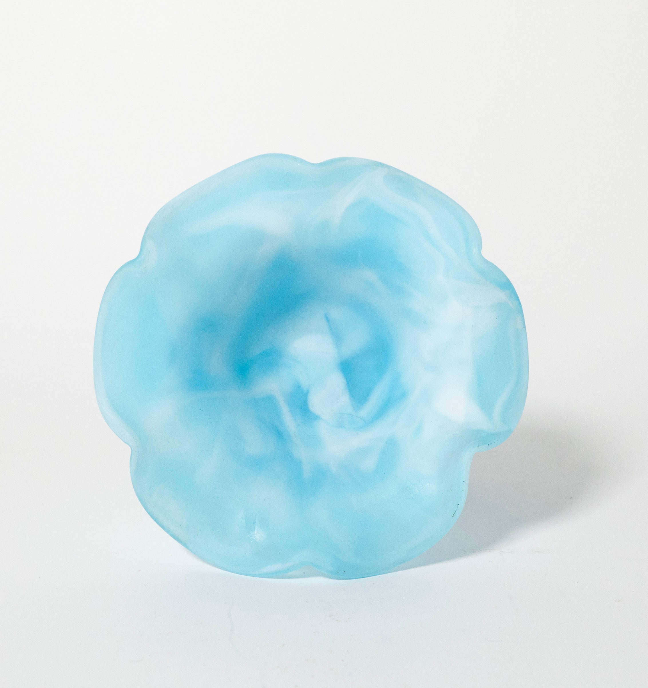 Blue flower-shaped object on a white background