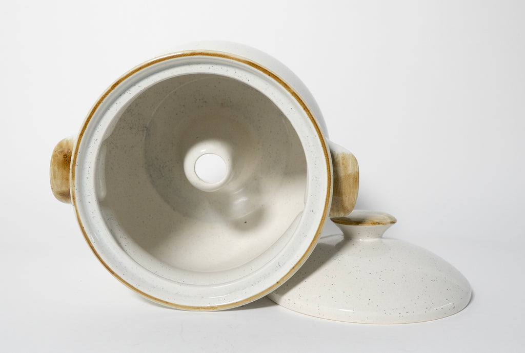 Ceramic pot with lid on a white background