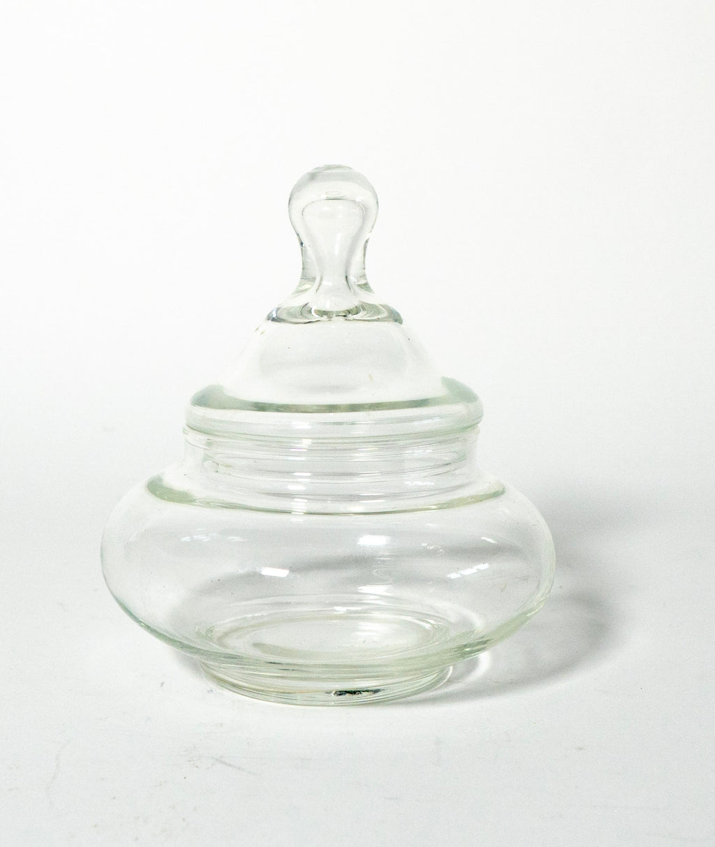 Clear glass jar with a lid on a white background