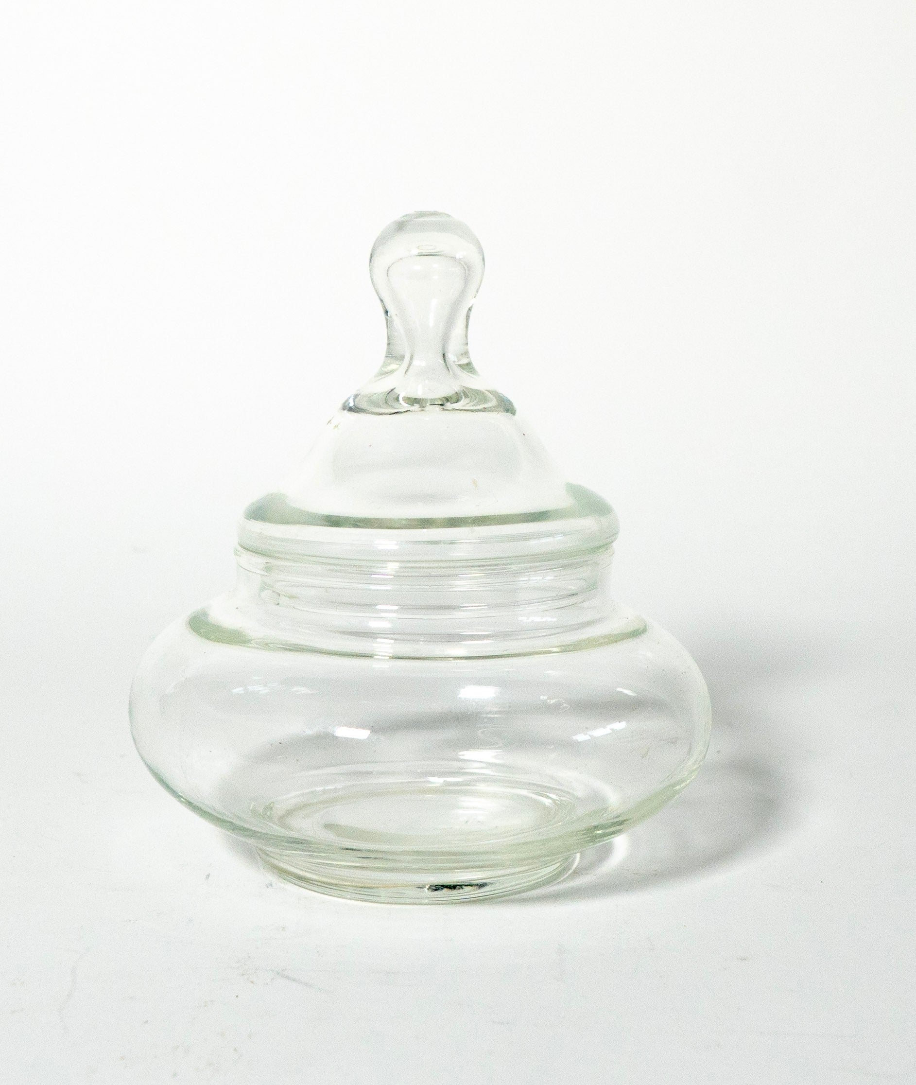 Clear glass jar with a lid on a white background